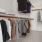 a room with a rack of clothes