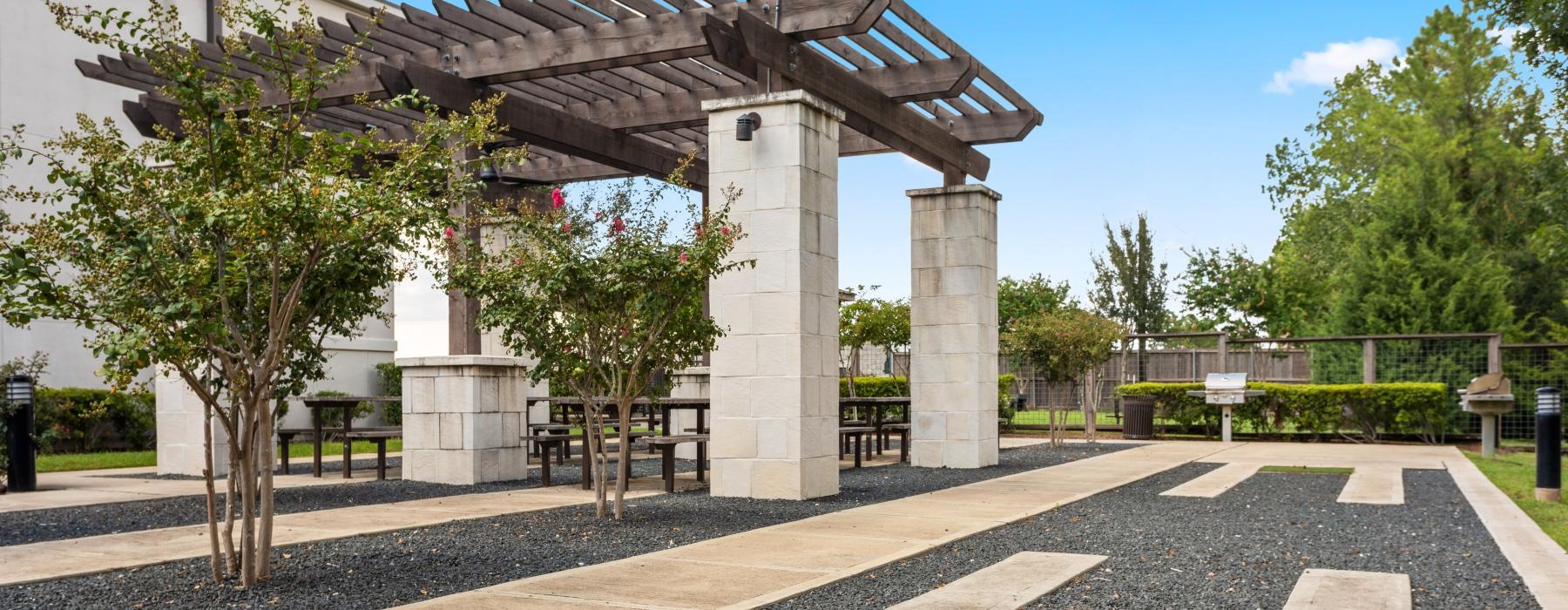 a building with pillars and a fence