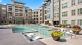 a pool in a courtyard with buildings around it