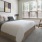 a bedroom with a bed and a chair